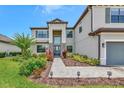 Elegant two-story home with stone accents, lush landscaping, and a welcoming entrance at 16231 Tradewind Ter, Bradenton, FL 34211