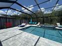 Inviting screened pool and jacuzzi spa with ample seating, perfect for outdoor relaxation and entertainment at 16231 Tradewind Ter, Bradenton, FL 34211