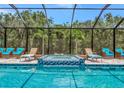Stunning screened-in pool area with a spa and ample seating for relaxing at 16231 Tradewind Ter, Bradenton, FL 34211
