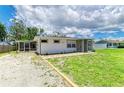 Quaint single-Gathering home features a screened-in porch and well-kept lawn at 2026 Arkansas Ave, Englewood, FL 34224