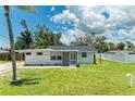 Inviting single-story home boasts a lush lawn and screened entry, blending comfort and curb appeal at 2026 Arkansas Ave, Englewood, FL 34224
