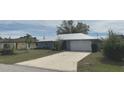 Charming single-story home with a long driveway and a well-manicured lawn and mature landscaping at 22321 Yonkers Ave, Port Charlotte, FL 33952