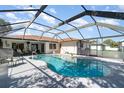 Inviting screened-in pool area with a clear blue pool and comfortable seating at 22434 Walton Ave, Port Charlotte, FL 33952