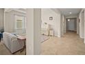 Open-concept living space with tile flooring, featuring a piano, a couch, and an airy hallway at 226 Tapa Parish Run, Bradenton, FL 34212