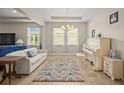 Bright living room featuring large windows, tile flooring, a piano and neutral-colored walls at 226 Tapa Parish Run, Bradenton, FL 34212