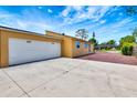 Exterior view of the home featuring a two-car garage and expansive driveway for parking at 2315 Riverwood Pines Dr, Sarasota, FL 34231