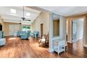 Open living room with vaulted ceilings, wood flooring and natural light from the window at 2315 Riverwood Pines Dr, Sarasota, FL 34231