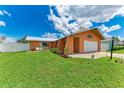 Bright home featuring a lovely lawn, crisp white fence, and a convenient one-car garage at 2406 15Th W St, Palmetto, FL 34221