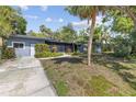 Street view of a charming single-story home with mature landscaping in a quiet neighborhood at 2850 Bon Air Ave, Sarasota, FL 34234