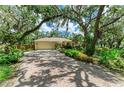 Beautiful home with a long brick driveway and lush landscaping at 3217 Oak Grove Dr, Sarasota, FL 34243