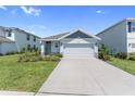 Charming single Gathering home with a well-manicured lawn and two car garage on a sunny day at 3355 Hilltop Cir, Bradenton, FL 34211