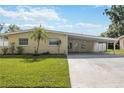 Delightful single-story house featuring a covered carport and a neat front yard at 3641 Stokes Dr, Sarasota, FL 34232