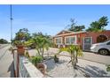 Delightful single-Gathering home with meticulous landscaping, complete with palm trees and white rock at 3957 Proctor Rd, Sarasota, FL 34233