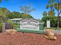 Strathmore Condominiums sign with lush landscaping, offering a welcoming entrance to the community at 4203 Schwalbe Dr # 115, Sarasota, FL 34235