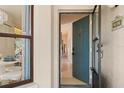 Inviting entryway featuring a teal door with a view into the well-lit hallway at 4411 46Th W Ave # 201, Bradenton, FL 34210