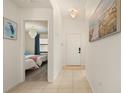 Bright hallway with tile flooring leads to a bedroom with two twin beds at 4411 46Th W Ave # 201, Bradenton, FL 34210