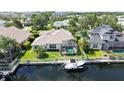 Aerial view of property showcasing backyard pool, boat dock, lush landscaping and canal front views at 4735 Starboard Dr, Bradenton, FL 34208