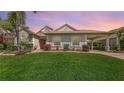 Charming single-story home boasts a well-manicured lawn, decorative shrubbery, and a convenient carport for easy parking at 4735 Starboard Dr, Bradenton, FL 34208