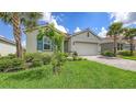 Charming single-story home with well-manicured lawn, tile roof and paver driveway at 491 Daylily Blvd, Nokomis, FL 34275