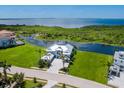 Expansive aerial view of the property showcasing lush landscaping, waterfront access, and a serene setting at 5630 Inspiration Ter, Bradenton, FL 34210