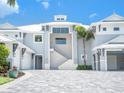 Elegant home featuring a neutral paint scheme, striking staircase, and well-lit facade at 5630 Inspiration Ter, Bradenton, FL 34210