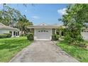 View of the garage and front entrance of the home at 5803 Garden Lakes Palm, Bradenton, FL 34203