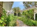 Lush landscaping surrounds the walkway to this property's front entrance at 5803 Garden Lakes Palm, Bradenton, FL 34203