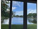 The canal-side view through the screen windows showcases the tranquility of waterfront living at 655 Spanish Way, Longboat Key, FL 34228