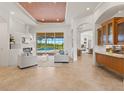 Bright living room featuring elegant decor, a cozy fireplace, and a view of the sparkling pool area at 7144 Ashland Gln, Lakewood Ranch, FL 34202