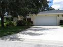 This house features a well-maintained lawn, a two car garage and manicured bushes at 7157 Fairway Bend Cir, Sarasota, FL 34243