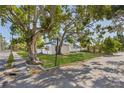 Attractive home featuring a well-manicured lawn and mature shade trees on a corner lot at 719 22Nd W St, Bradenton, FL 34205