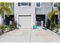 Inviting townhome features a well-manicured front yard and an attached one-car garage at 8979 Milestone Dr, Sarasota, FL 34238