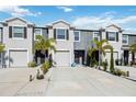 Charming townhomes with well-maintained landscaping, driveways, and two-car garages at 8979 Milestone Dr, Sarasota, FL 34238