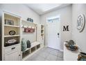 Welcoming foyer features built-in storage, bench, and decor accents at 8979 Milestone Dr, Sarasota, FL 34238