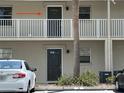 Exterior view showcasing unit #4, set on a balcony above unit #3, with convenient parking and landscaping at 900 La Costa Cir # 4, Sarasota, FL 34237