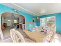 Bright dining room with colorful walls, a large table, and lots of natural light at 10095 Nassau Ct, Seminole, FL 33776