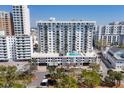 Exterior view of condo with poolside amenities on top of garage overlooking lush trees and the city at 101 S Gulfstream Ave # 15C, Sarasota, FL 34236