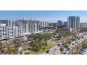 Exterior cityscape view showcasing condo buildings, lush landscaping, and a picturesque street at 101 S Gulfstream Ave # 15C, Sarasota, FL 34236