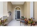 Inviting front porch with chairs, plants, and a decorative door, creating a welcoming and cozy entry at 11610 Griffith Park Ter, Bradenton, FL 34211