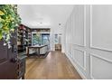 Elegant foyer with wood floors, large bookcase, and stylish decor at 13640 2Nd E Ave, Bradenton, FL 34212
