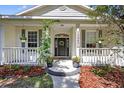 Inviting front porch with decorative plants and a wreath on the front door at 13640 2Nd E Ave, Bradenton, FL 34212