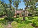 Inviting home with mature landscaping and well-manicured lawn at 1509 Shadow Ridge Cir, Sarasota, FL 34240