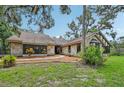 Charming stone home featuring lush landscaping and a welcoming facade at 1509 Shadow Ridge Cir, Sarasota, FL 34240