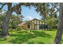 Well-manicured front yard showcasing a charming home with unique architectural details at 1509 Shadow Ridge Cir, Sarasota, FL 34240