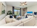 Bright living room featuring a large sectional sofa, view of the pond, and a staircase leading to the second floor at 15225 Lyla Ter, Bradenton, FL 34211