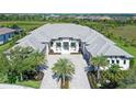 Elegant home exterior featuring a grand facade, well-manicured landscaping, and a spacious paver driveway at 15315 Anchorage Pl, Lakewood Ranch, FL 34202