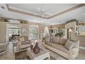 Inviting living room boasts tile flooring, comfortable seating, and a bright, open layout at 2016 White Feather Ln, Nokomis, FL 34275