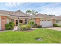 Charming single-story home featuring a well-manicured lawn and front walkway at 2025 Lynx Run, North Port, FL 34288