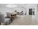 Open concept living area with modern furnishings and light wood floors at 2155 Harbourside Dr # 804, Longboat Key, FL 34228
