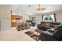 Bright living area with tile flooring, ceiling fan, and kitchen island seating at 2761 Feiffer Cir, Sarasota, FL 34235
